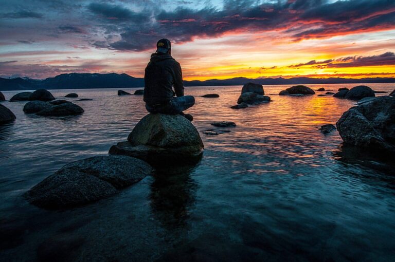 Boy Sitting On Rock